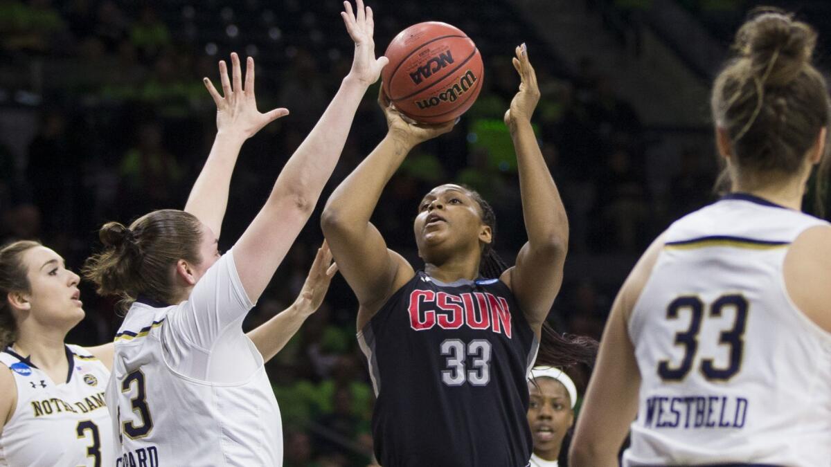 Cal State Northridge's Channon Fluker goes up for a shot between Notre Dame's Marina Mabrey (3), Jessica Shepard (23) and Kathryn Westbeld (33) during their game Friday.