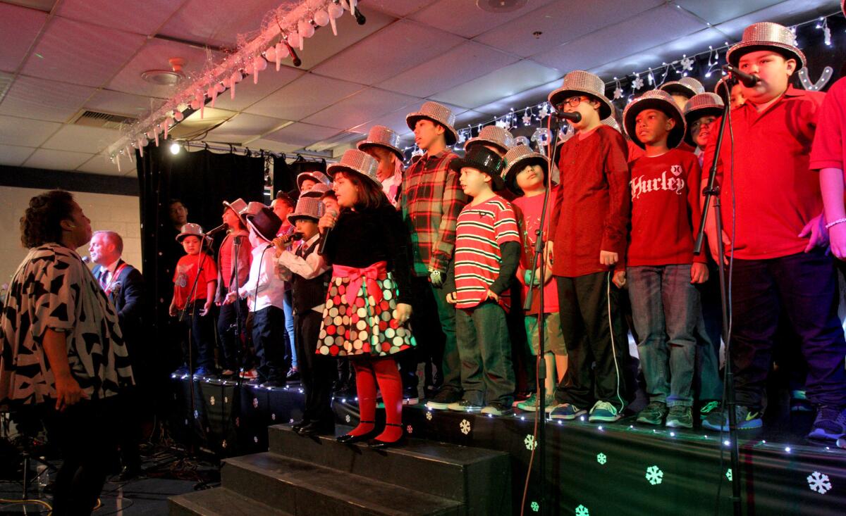 Members of the Elementary School Choir sing "Hello, Dolly" during the annual Tobinworld Holiday Show & Open House at the school in Glendale on Friday, Dec. 18, 2015.