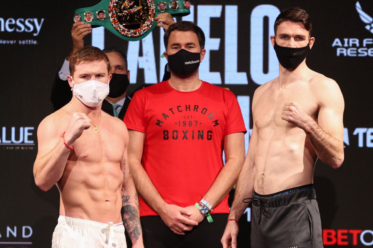 Canelo Alvarez and Callum Smith pose after weighing in Friday for their fight at the Alamodome in San Antonio, Texas.