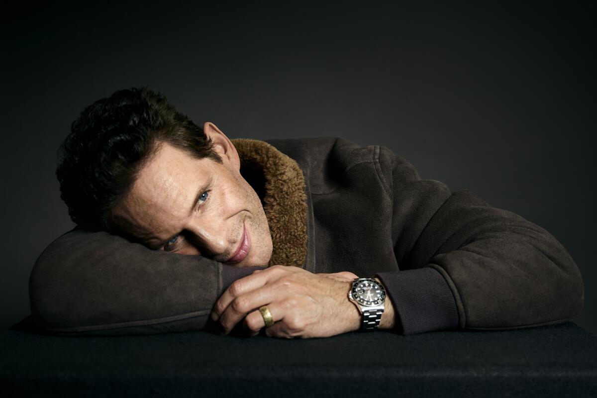  Glenn Howerton lays his head on his arm while posing for a portrait.