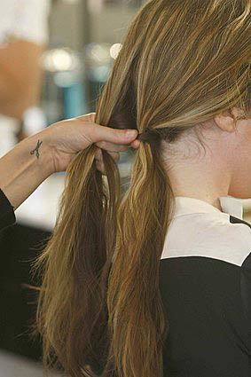 "This [fishtail] style works best on someone with medium to longer hair," Roszak says. "Hair should be a few inches past the shoulders to try this." Step 1: Make a clean part on top of your head, either down the middle or slightly on the side. From there, pull hair into two sections at the nape of the neck and angle the sections to the side of your head so that you can see and hold the hair you're working with. MORE HAIR AND BEAUTY TIPS How to eliminate dark circles under the eyes How to apply bronzer In pursuit of a longer-lasting perfect manicure How to rock a half up, half down hairstyle Fashion and beauty news in the Image section's blog