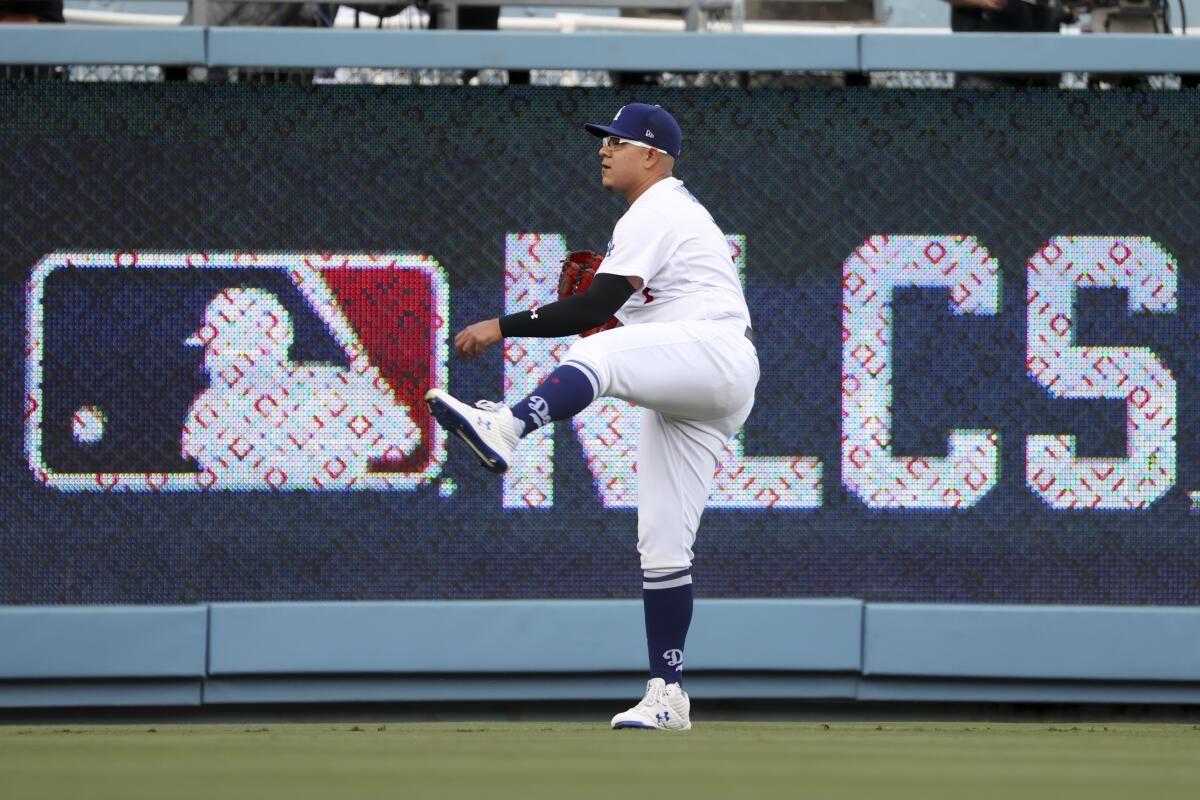 Dodgers starting pitcher Julio Urías warms up before Game 4 of the NLCS against the Braves at Dodger Stadium.