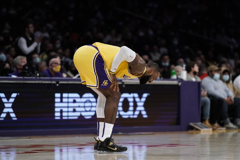Los Angeles Lakers' LeBron James reacts to a foul called on him during first half of the team's NBA basketball game against the Phoenix Suns on Tuesday, Dec. 21, 2021, in Los Angeles. (AP Photo/Jae C. Hong)