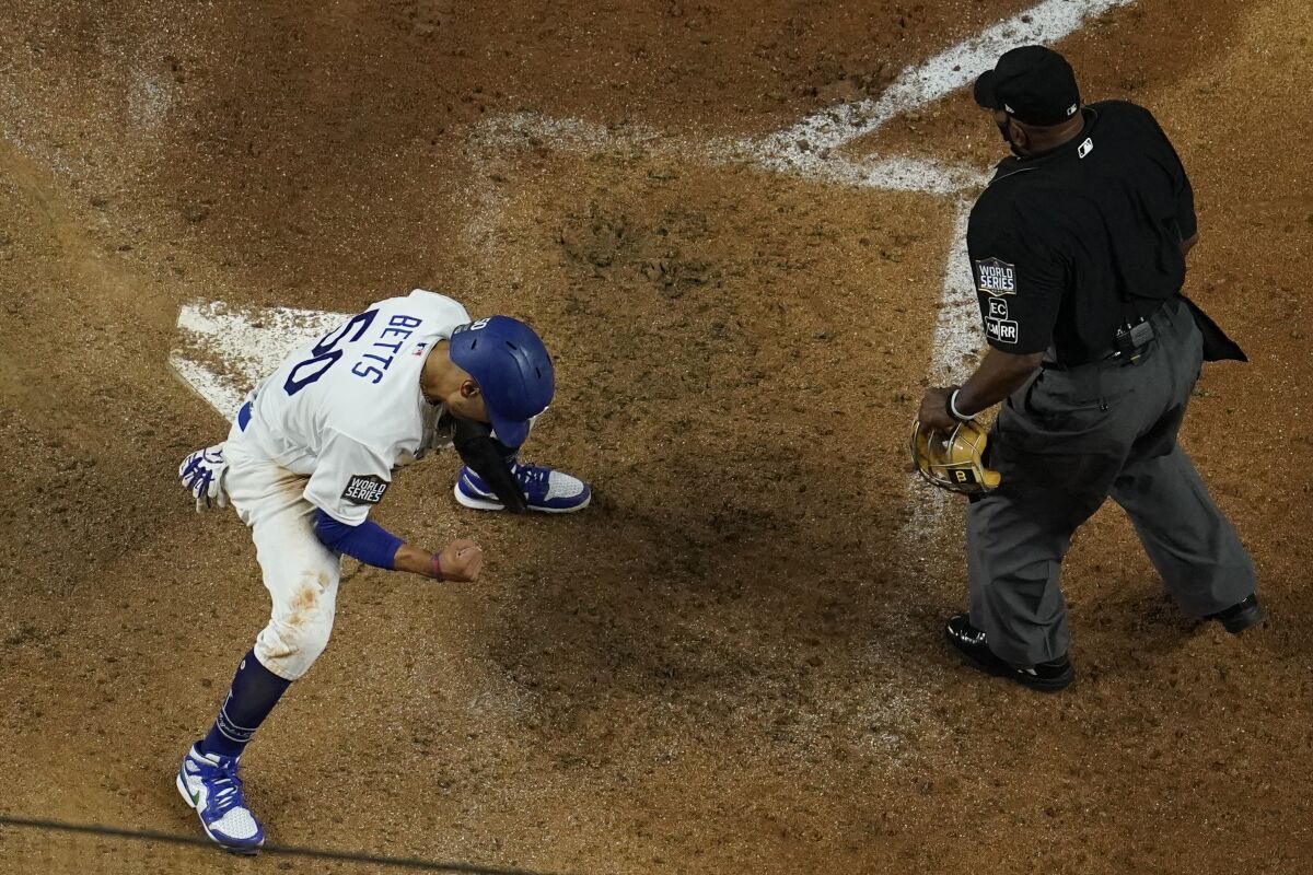 Dodgers' Mookie Betts reacts after scoring on a fielders choice.