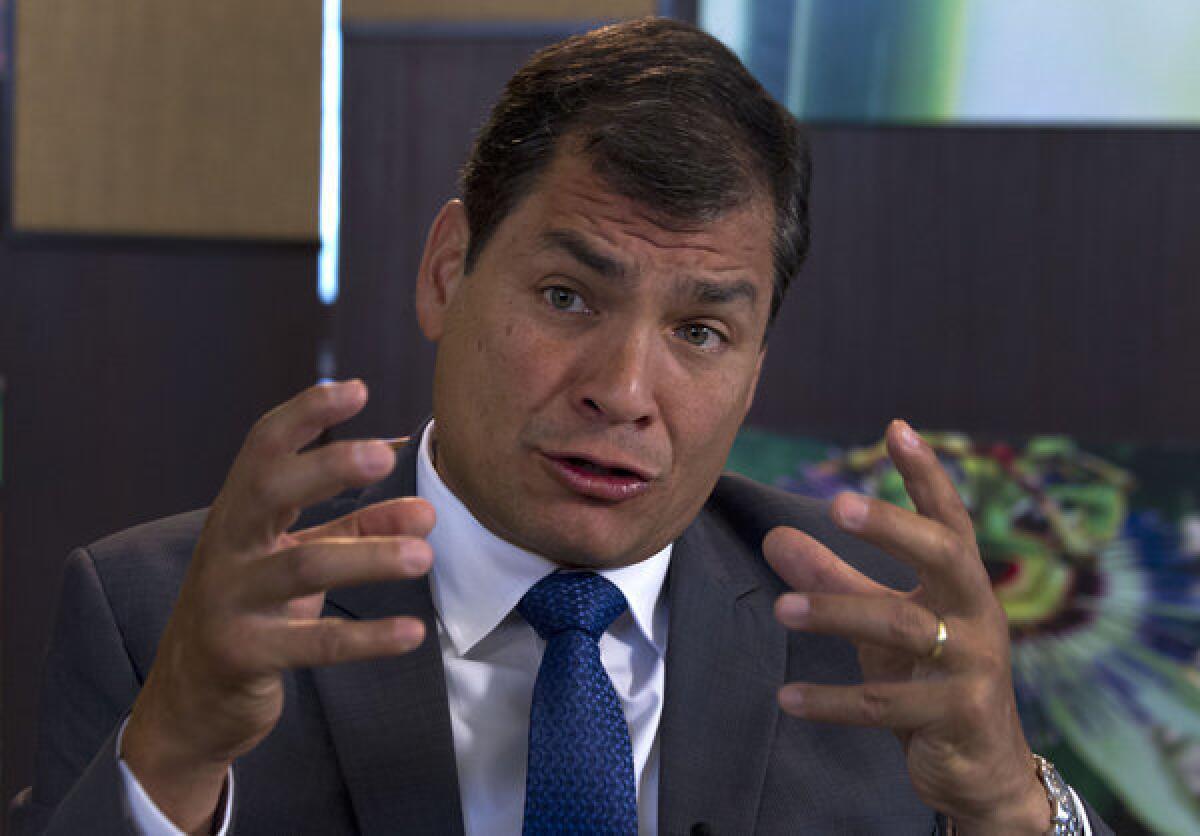 Ecuador's President Rafael Correa speaks during an interview Sunday with Associated Press in Portoviejo, Ecuador. Correa said Edward Snowden must assume responsibility if he broke U.S. laws.