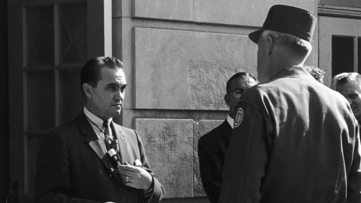 Brigadier Gen. Henry Graham, right, of the Alabama National Guard asks Gov. George Wallace to step aside on order of the president to allow racial integration at the University of Alabama in Tuscaloosa in 1963..