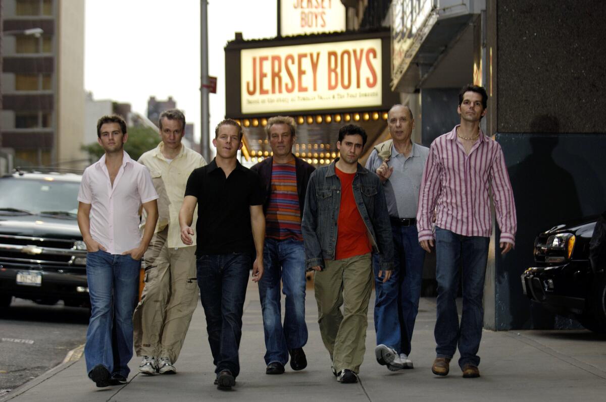 The cast and crew of "Jersey Boys" in front of the Virginia Theatre in New York in August 2005: actor Daniel Reichard, left, co-writer Rick Elice, actor Christian Hoff, director Des McAnuff, actor John Lloyd Young, co-writer Marshall Brickman, and actor J. Robert Spencer.
