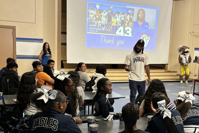 Rams safety John Johnson III talks to kids at the Edwin Markham Middle School in Watts.