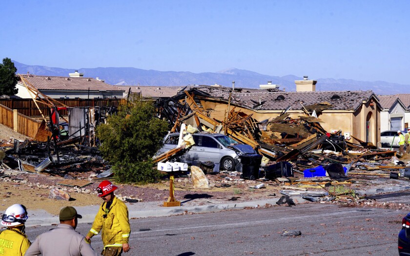 Law enforcement and fire authorities investigate the remains of a house explosion on Wednesday, June 29, 2022, in Victorville, Calif. (Hugo Valdez/Victor Valley News VVNG.com via AP)