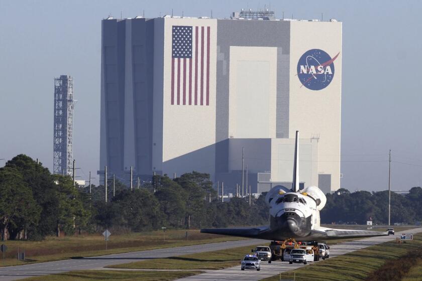 The Vehicle Assembly Building (with the space shuttle Atlantis in the foreground) at the Kennedy Space Center in Titusville, Fla.