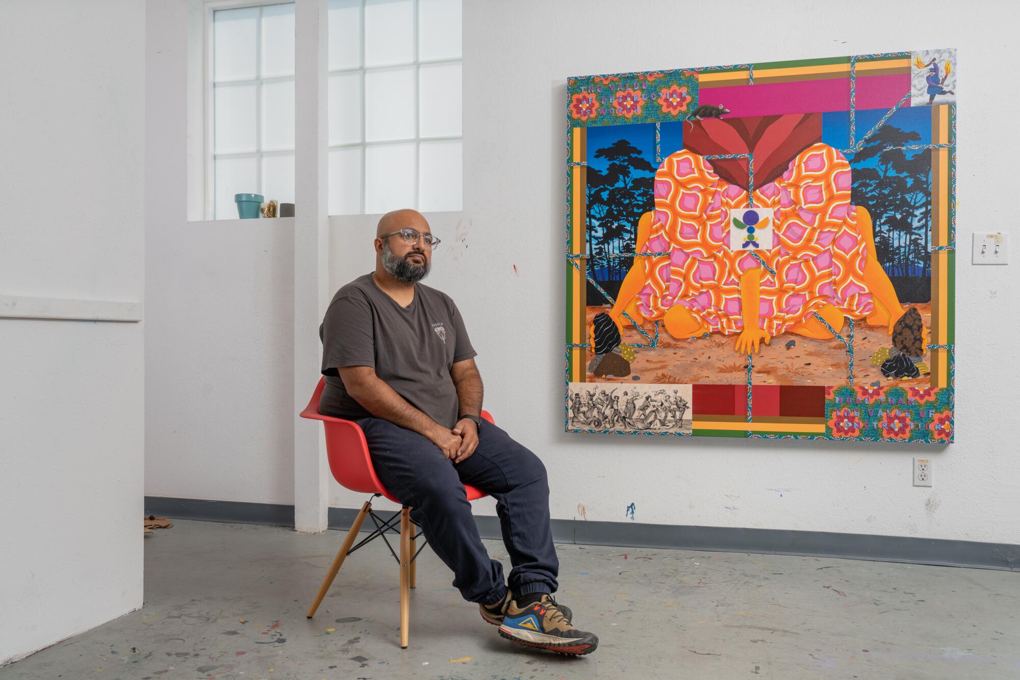 A portrait of the artist Amir H. Fallah with his painting.