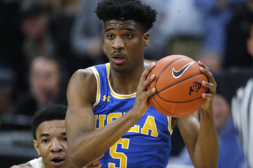 UCLA guard Chris Smith, front, drives to the rim past Colorado guard Tyler Bey in the first half of an NCAA college basketball game Saturday, Feb. 22, 2020, in Boulder, Colo. (AP Photo/David Zalubowski)