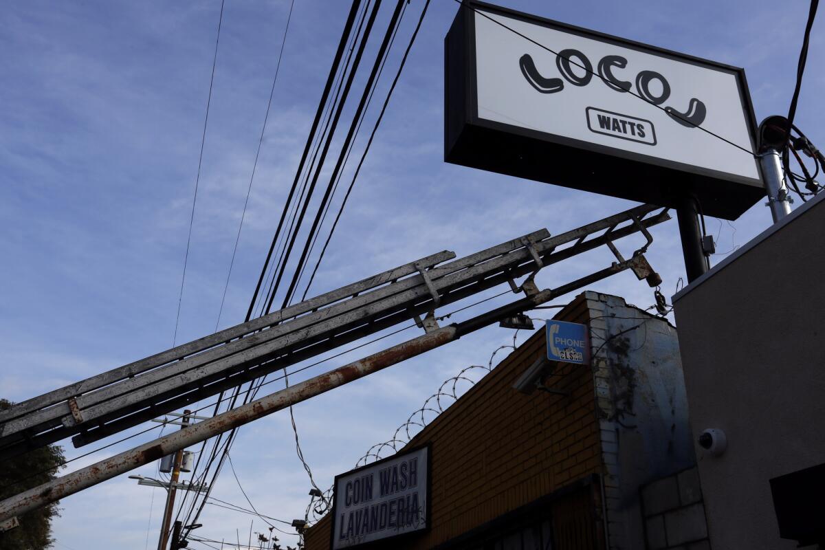 A business sign for LocoL is being installed.