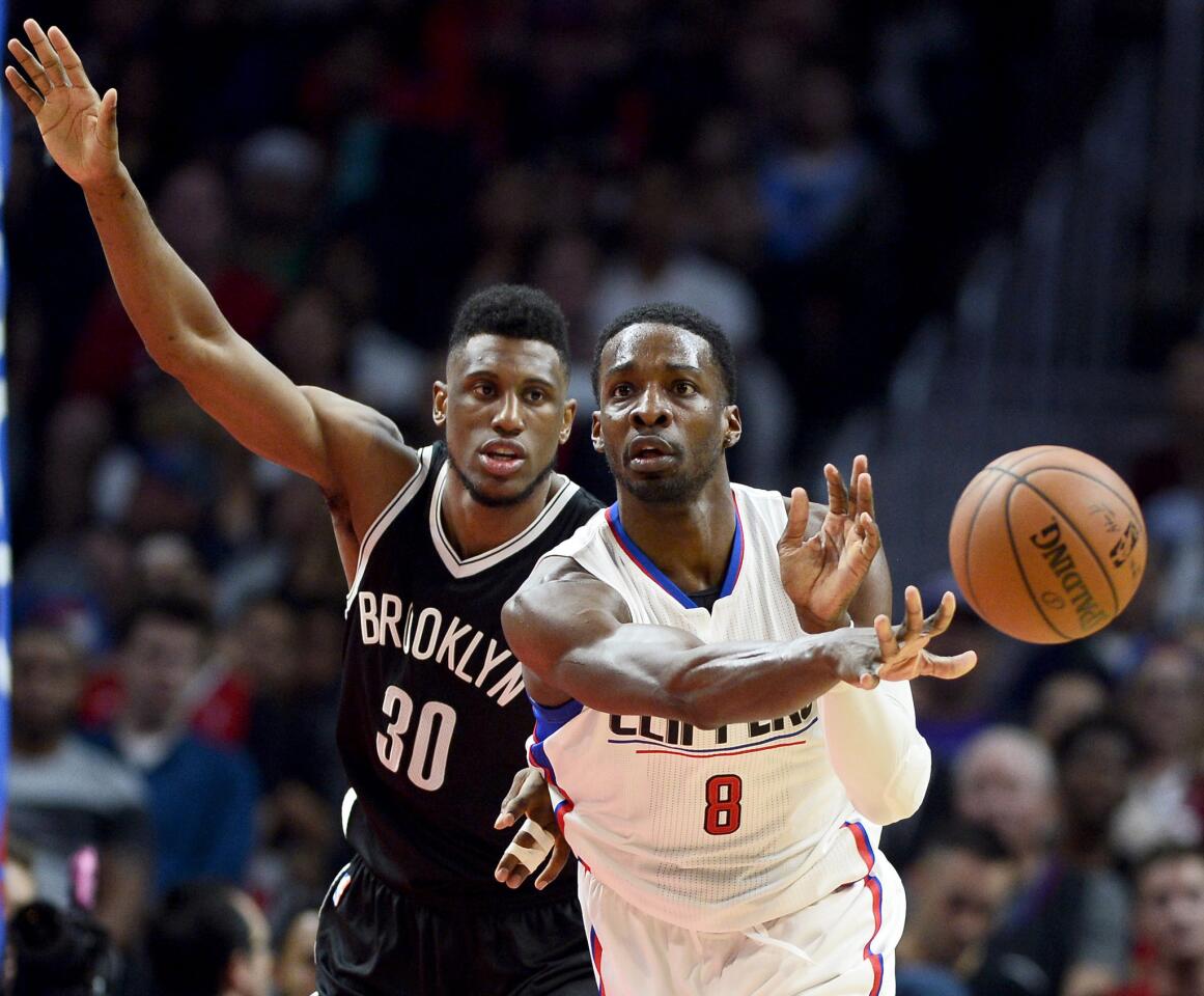 Clippers forward Jeff Green (8) passes ahead as Nets forward Thaddeus Young (30) chases after him in the second half.