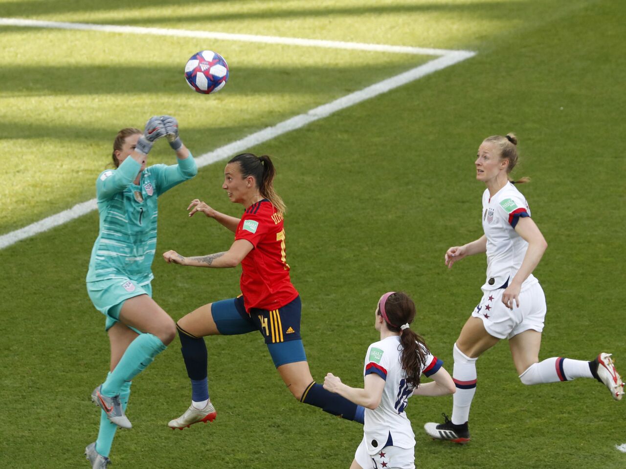 U.S. goalkeeper Alyssa Naeher, left, makes a save in front of Spain's Virginia Torrecilla.