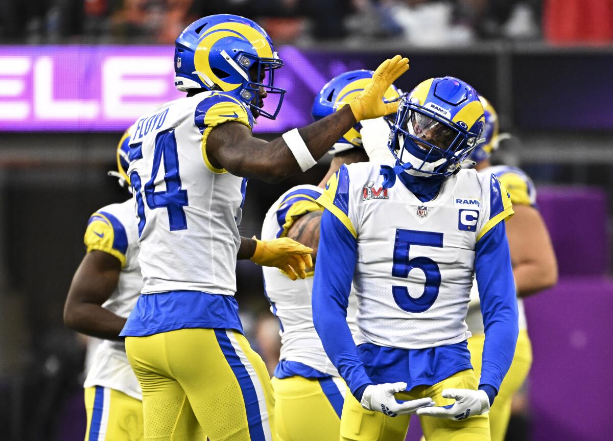 Rams cornerback Jalen Ramsey celebrates with teammate Leonard Floyd during Super Bowl LVI.