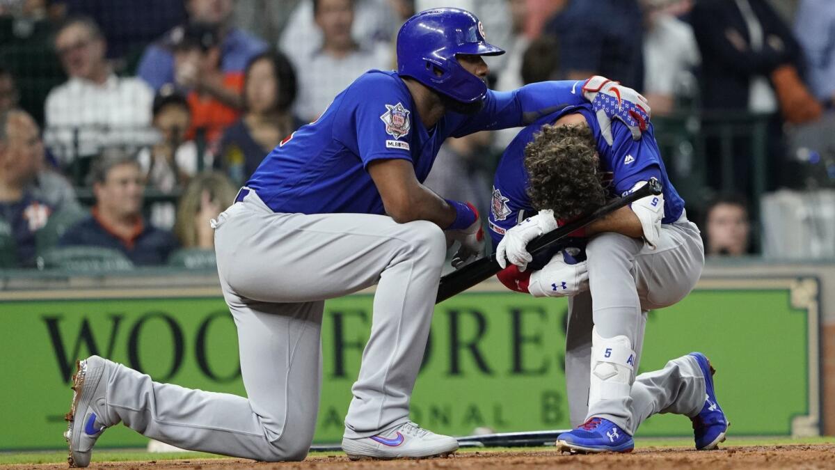 Chicago Cubs' Albert Almora Jr., right, is comforted by Jason Heyward after hitting a foul ball that struck a young girl May 29 in Houston.