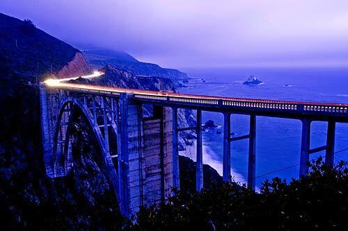A time-exposure photo shows traffic on Pacific Coast Highway going over the historic Bixby Bridge in Big Sur.