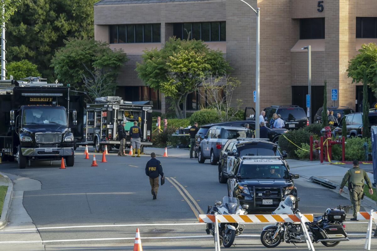 FBI and Orange County Sheriff department investigators at a medical building that housed the day spa bombed May 15, 2018.