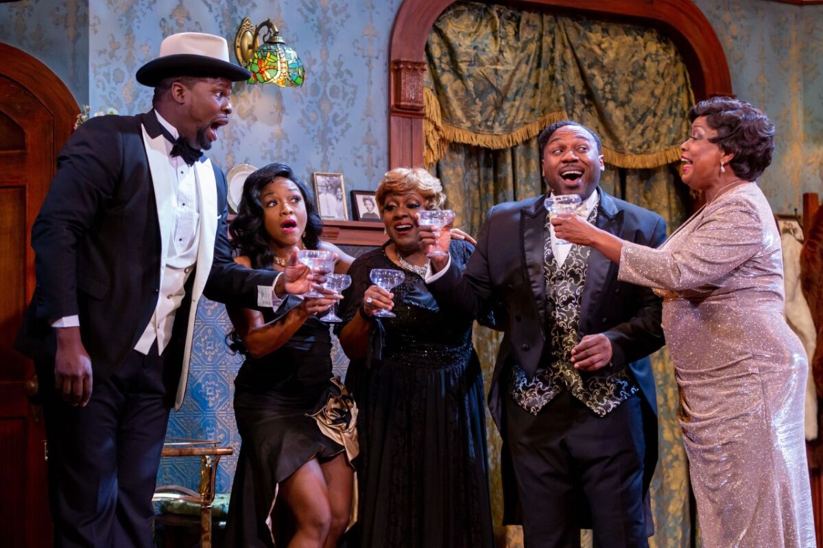 Five cast members of "Ain't Misbehavin'" toast with glasses in their hands.