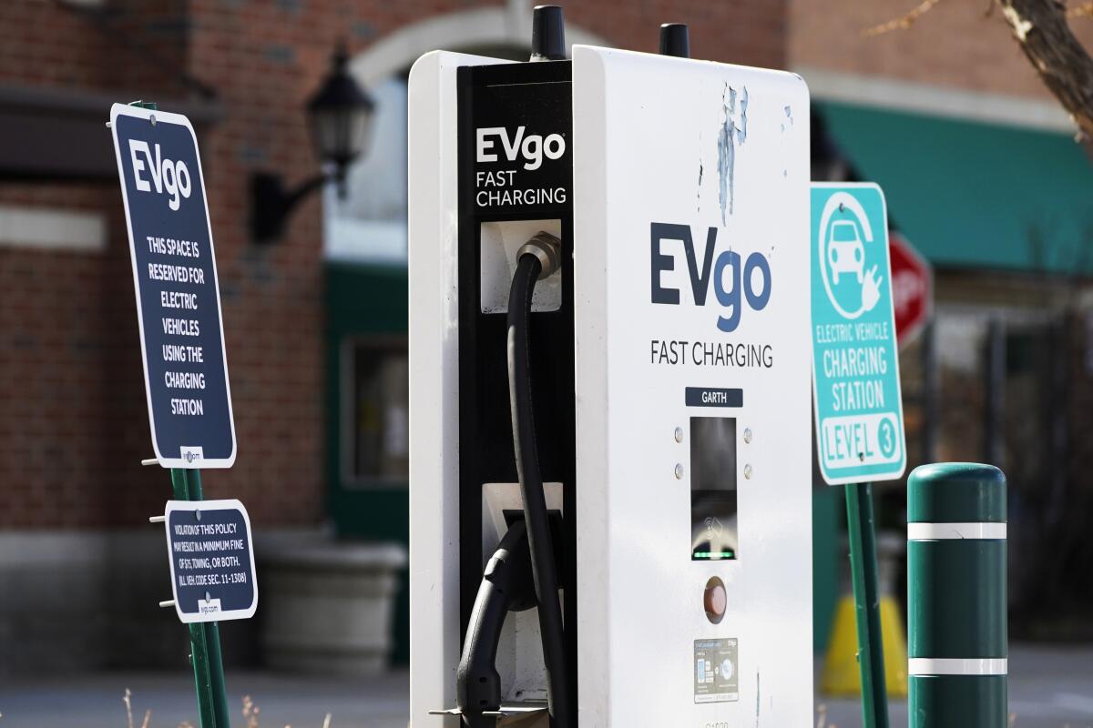 A EVgo electric vehicle charging station is seen at Willow Festival shopping plaza parking lot in Northbrook, Ill., Wednesday, March 31, 2021. President Joe Biden will unveil his $2 trillion infrastructure plan and the proposal calls to build a national network of 500,000 electric vehicle chargers by 2030 and replace 50,000 diesel public transit vehicles. (AP Photo/Nam Y. Huh)