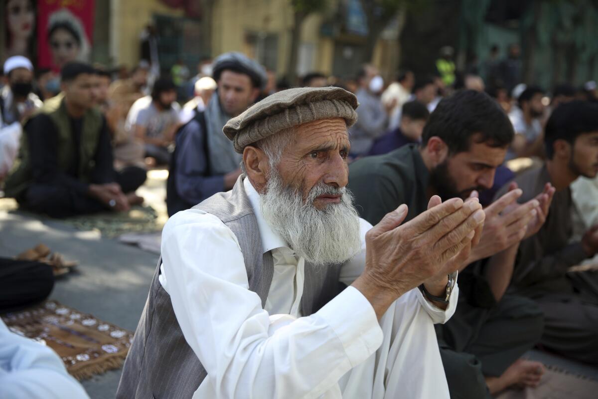 Men pray outside a mosque in Kabul, Afghanistan
