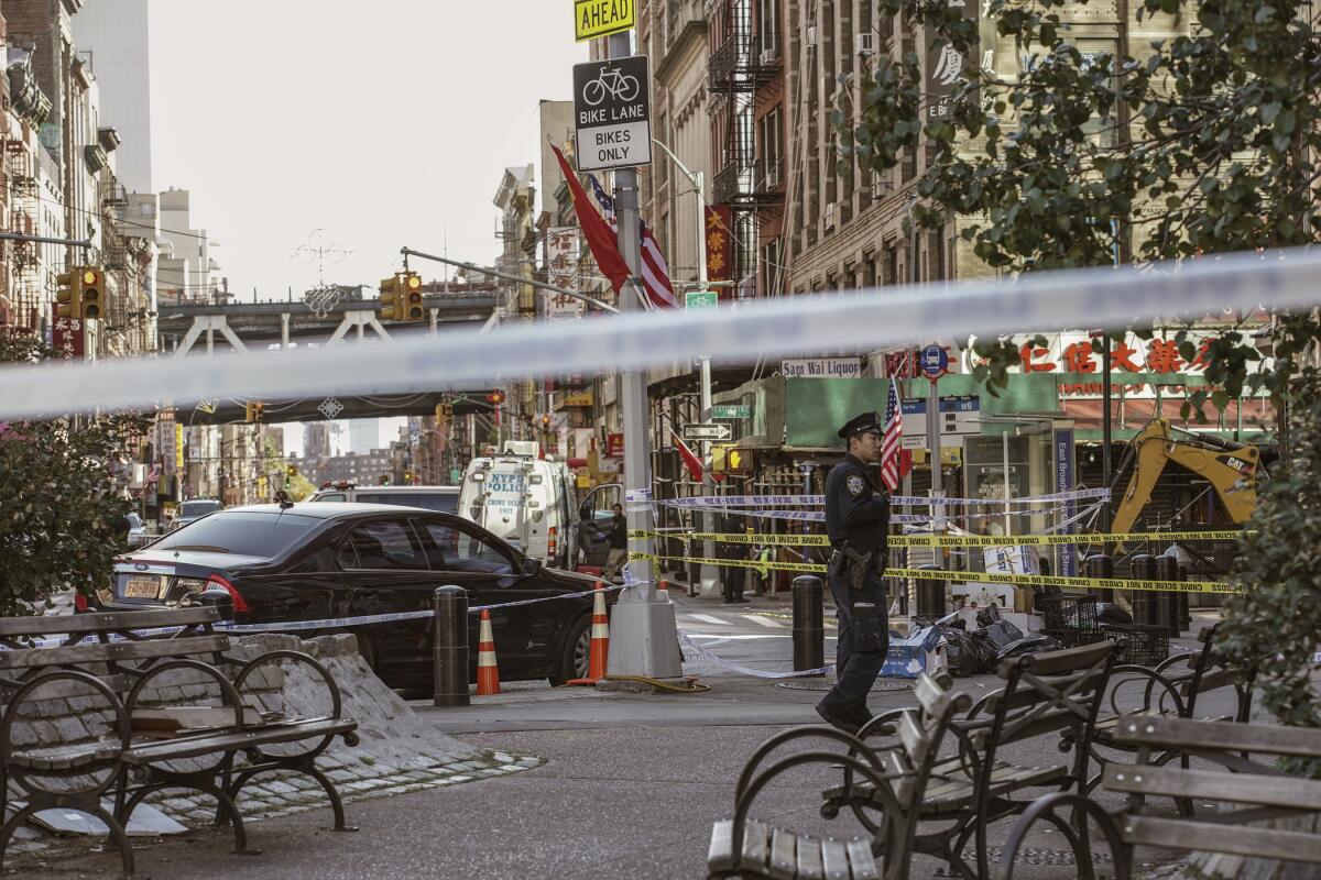 A police officer stands at the scene of the attack in Manhattan's Chinatown.