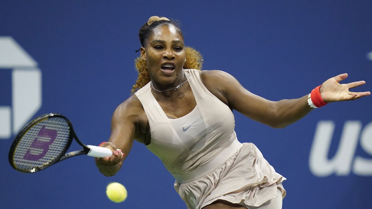 Serena Williams returns a shot during her loss to Victoria Azarenka.