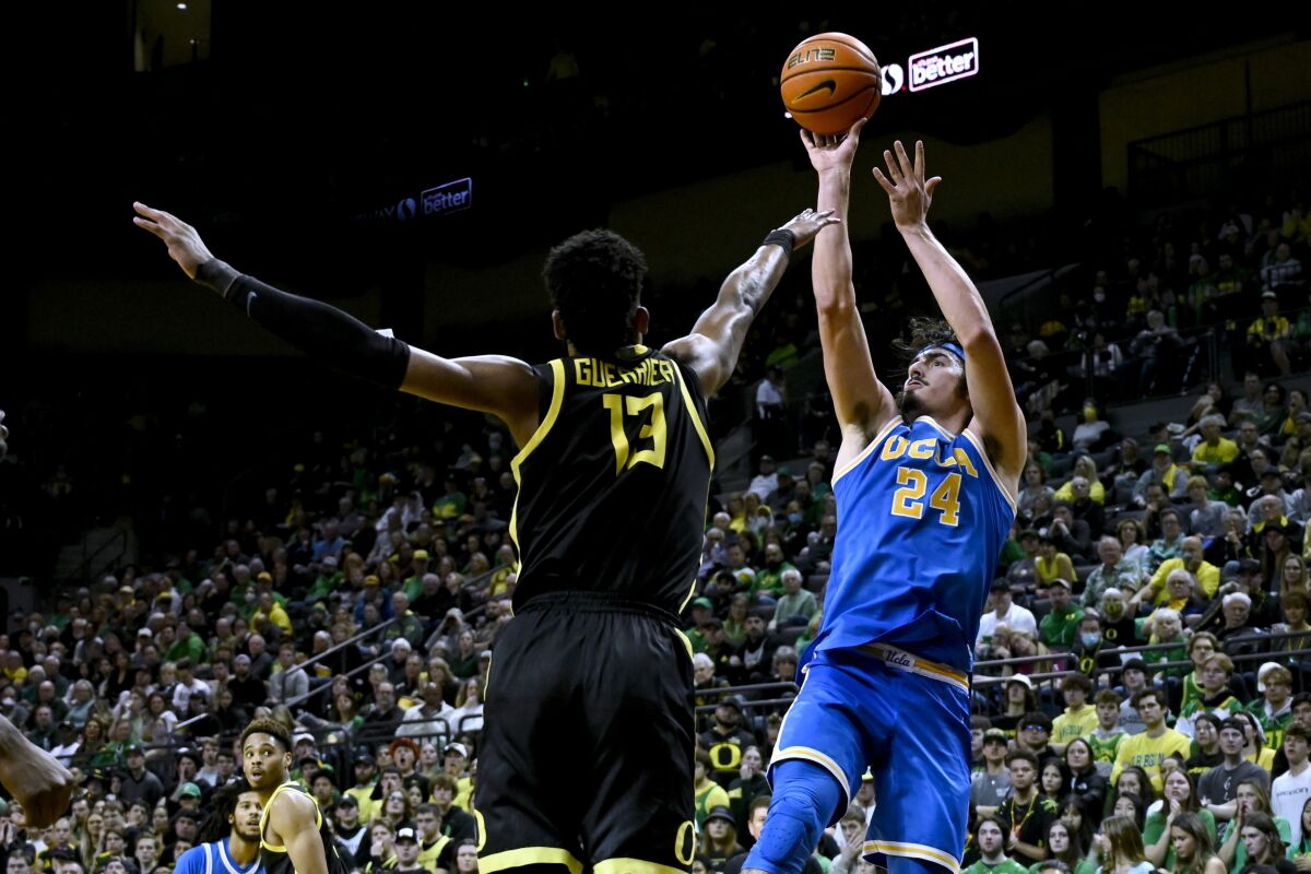UCLA's Jaime Jaquez Jr. shoots over Oregon's Quincy Guerrier on Feb. 11, 2023, in Eugene, Ore.