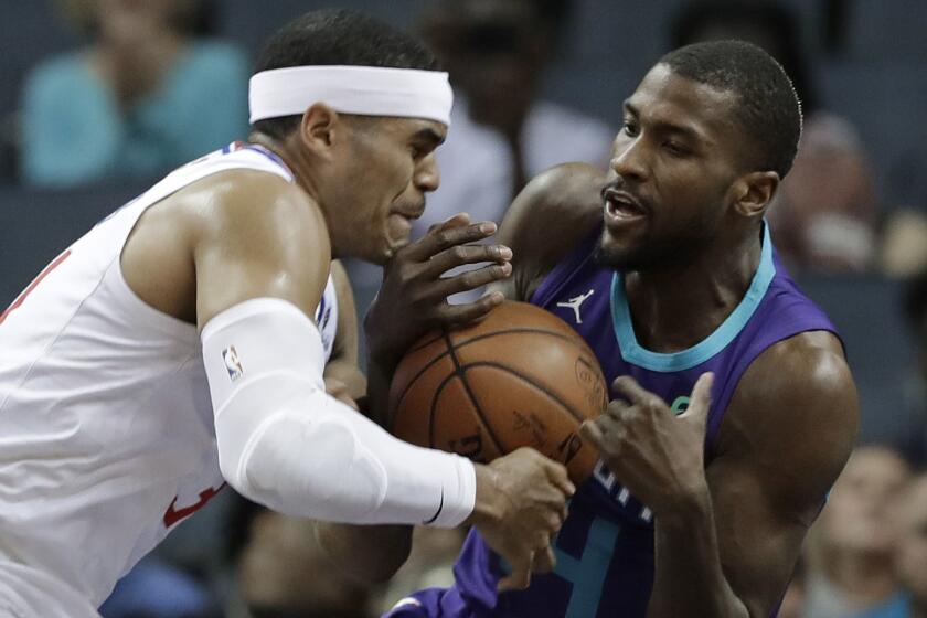 Charlotte Hornets' Michael Kidd-Gilchrist, right, steals the ball from Los Angeles Clippers' Tobias Harris, left, during the first half of an NBA basketball game in Charlotte, N.C., Tuesday, Feb. 5, 2019. (AP Photo/Chuck Burton)