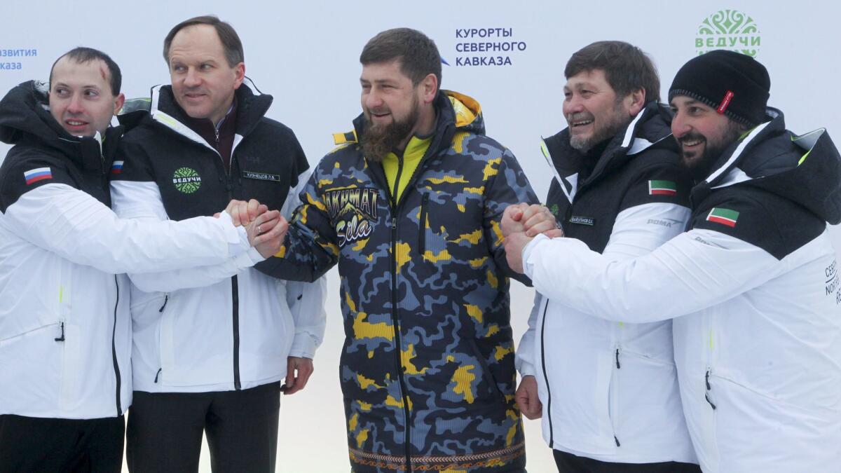 Chechen leader Ramzan Kadyrov is flanked by Russian Minister for North Caucasus Affairs Lev Kuznetsov, second from left, and other officials at the opening ceremony for the Veduchi ski resort.