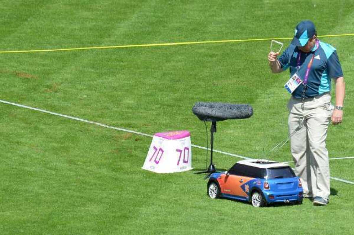A remote-controlled car brings back a hammer during the men's hammer throw qualifying round.