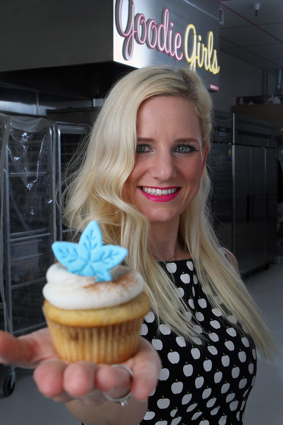 Chef-Owner Annette Starbuck, at Goodie Girls Cupcakes, holds a cinnamon roll cupcake in La Cañada Flintridge on Thursday, Dec. 12, 2013.