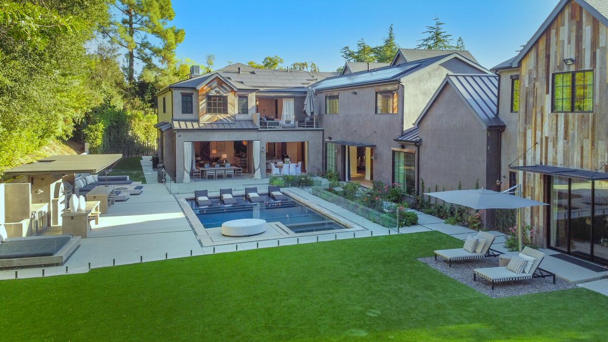 A pool is outside a home.