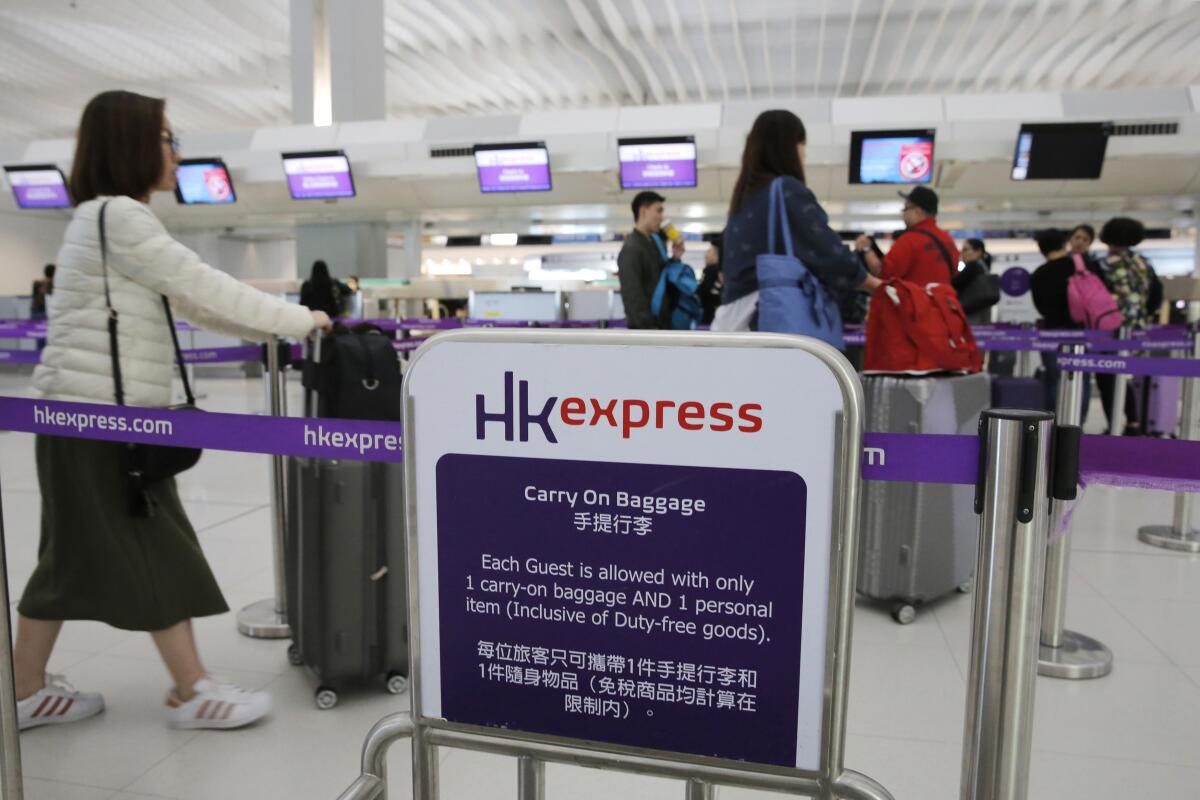 Travelers at Hong Kong International Airport.