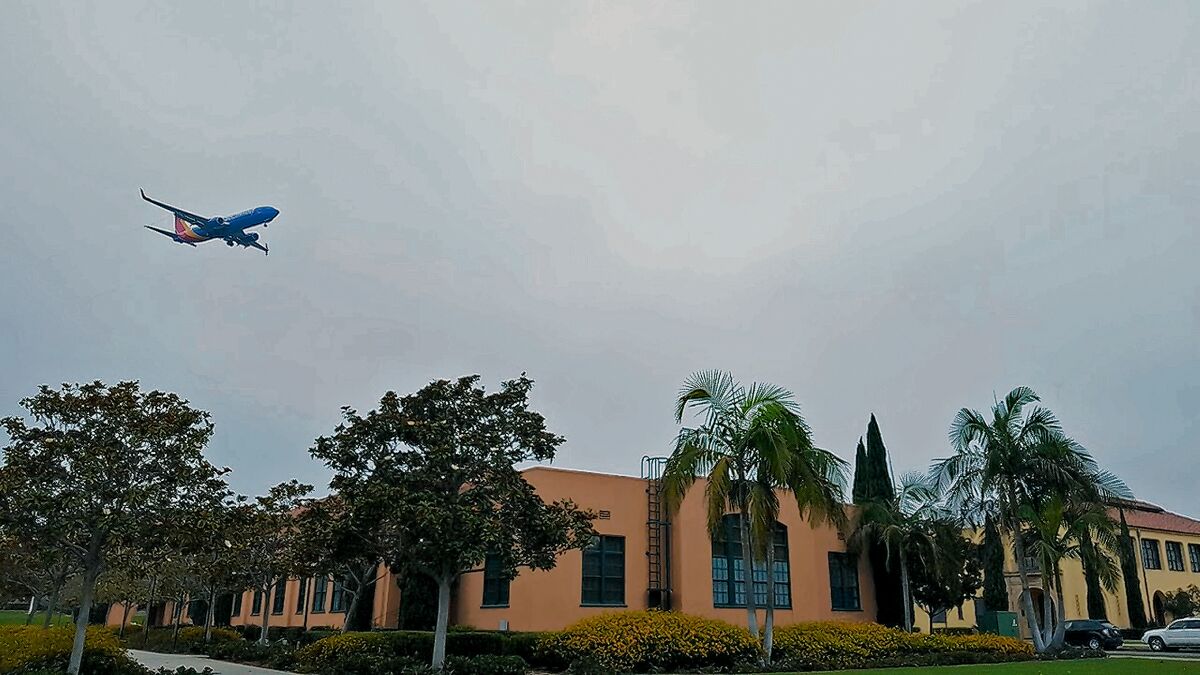An airplane flies low over Liberty Station in Point Loma.