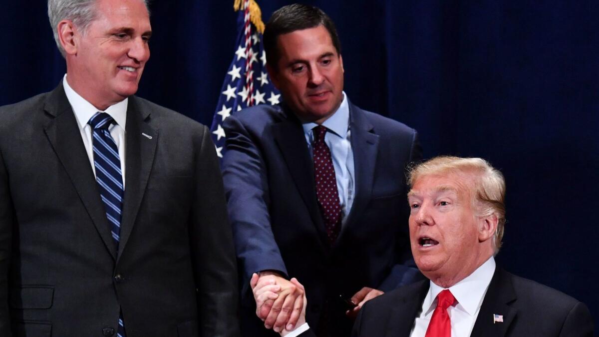 President Trump shakes hands with Rep. Devin Nunes, the Tulare Republican who has chaired the House Intelligence Committee for the last two years.