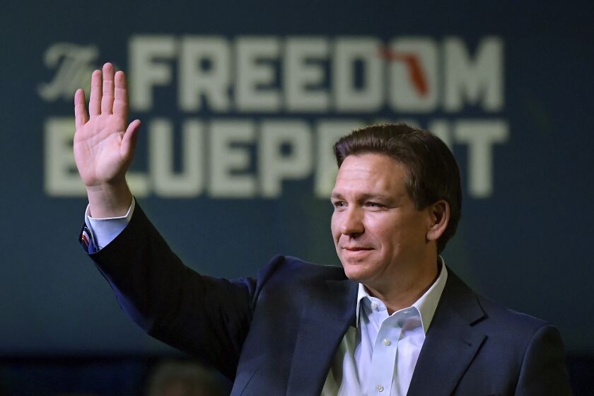 Florida Gov. Ron DeSantis waves to the crowd as he attends a campaign event Friday, March 10, 2023, in Davenport, Iowa. (AP Photo/Ron Johnson)