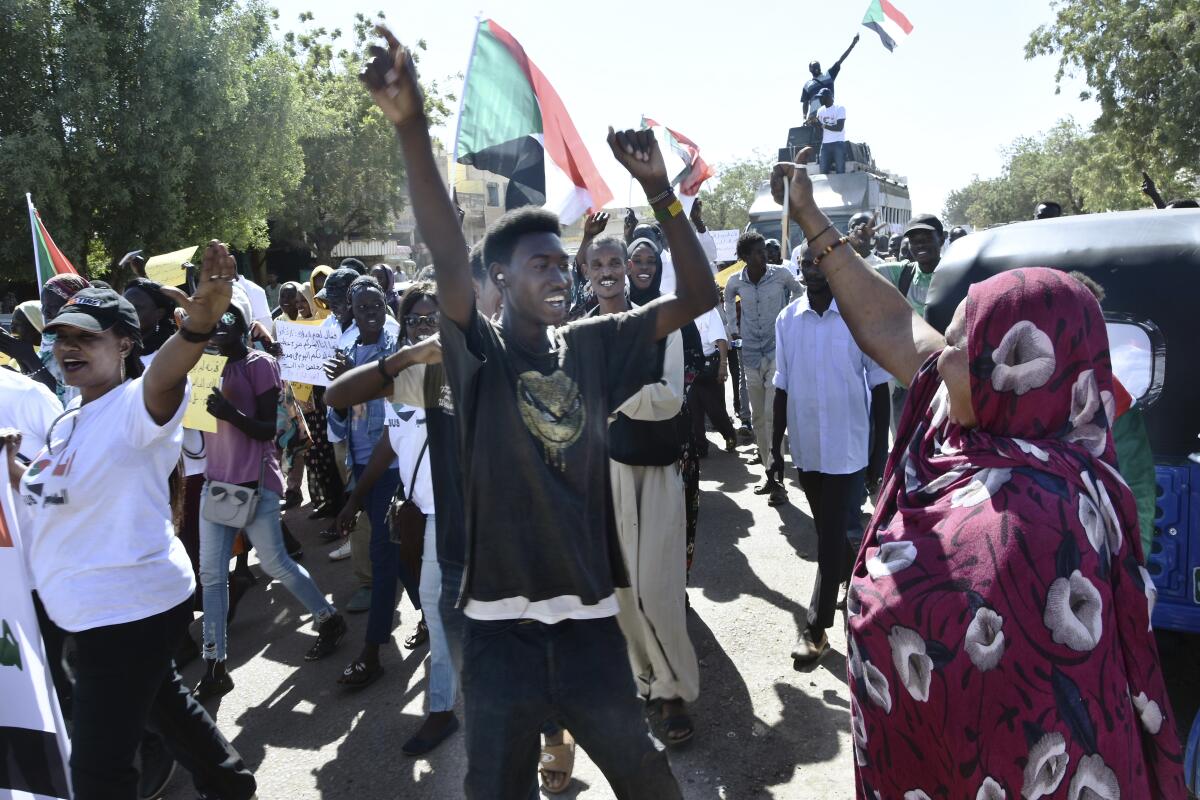 In this Monday, Dec. 23, 2019 photo, Christians march through the streets to celebrate the birth of Jesus in Khartoum Bahri, Sudan, north of the capital Khartoum. More than eight months after the army forced out long-ruling autocrat Omar al-Bashir, who upheld harsh interpretations of Islamic laws, Sudanese Christians are hoping for more religious freedom. (AP Photo/Mohamed Okasha)