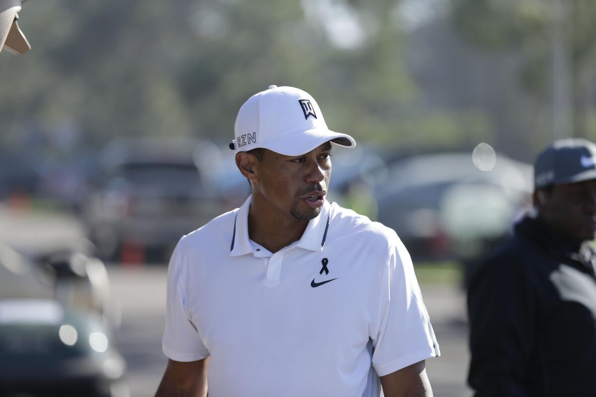 Former No. 1 golfer Tiger Woods loads his car after withdrawing from the Farmers Insurance Open at Torrey Pines on Feb. 5. Woods announced Wednesday he will be taking an indefinite leave from the sport.