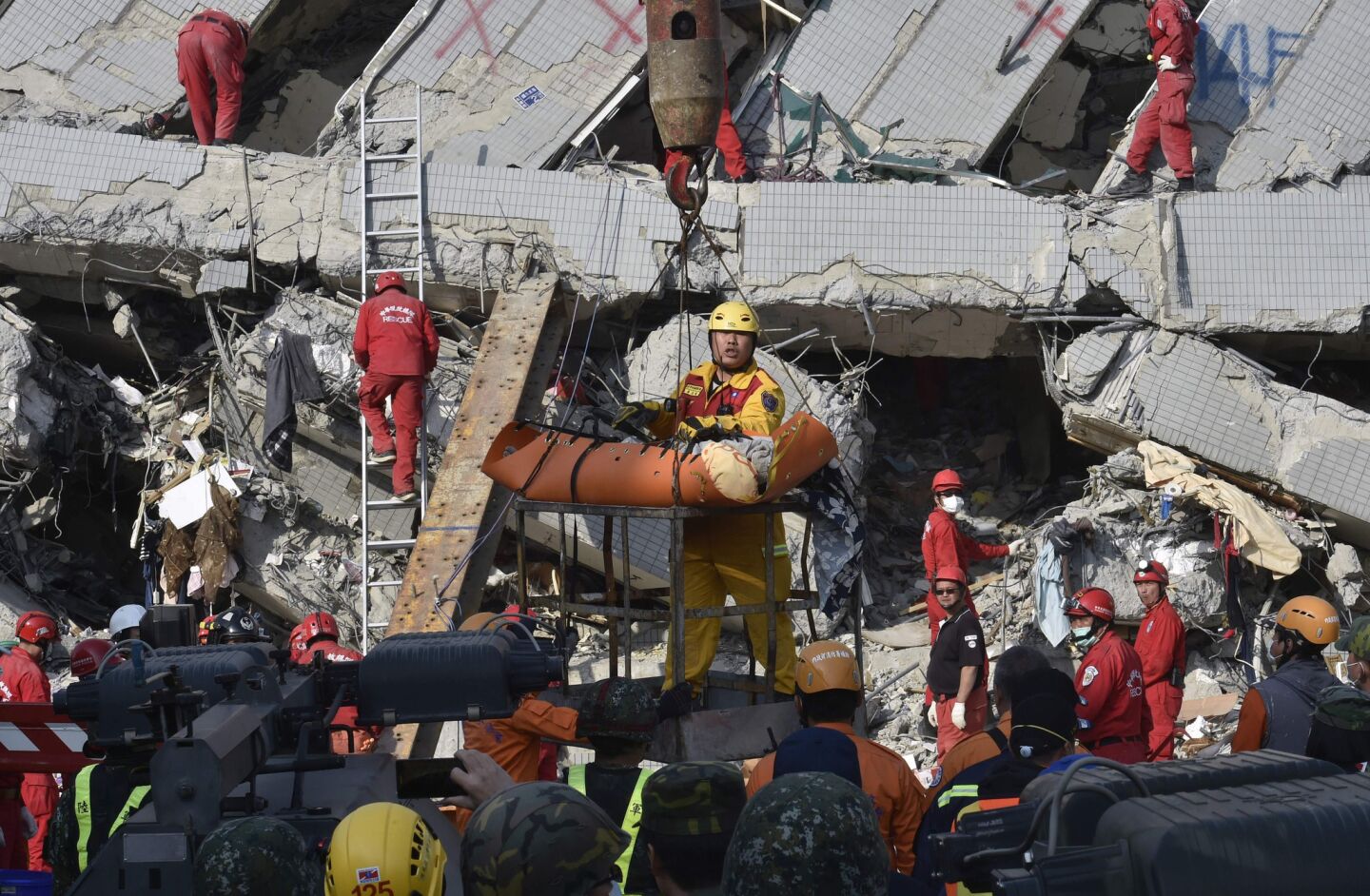 A rescue worker brings a victim down from the collapsed Wei Kuan complex in Tainan, southern Taiwan.