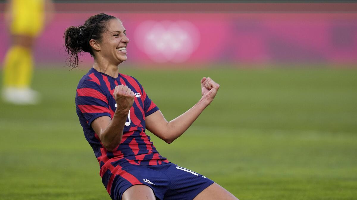 Carli Lloyd of the U.S. drops to her knees and pumps both fists.