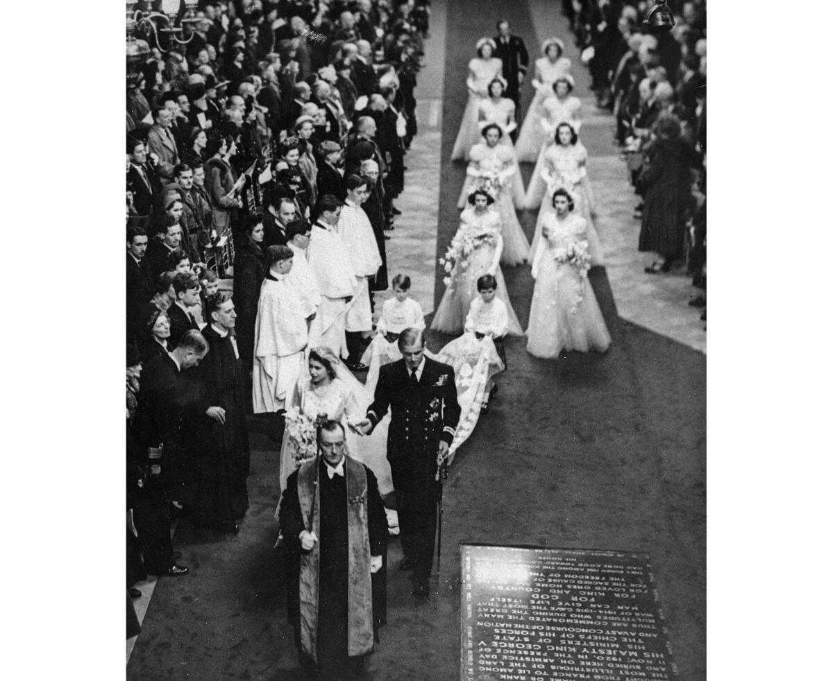 Led by the Very Rev. Alan Campbell Don, Dean of Westminster Abbey, Princess Elizabeth and her husband, Prince Philip, Duke of Edinburgh, pass the Tomb of the Unknown Soldier as they walk toward the west door of Westminster Abbey.