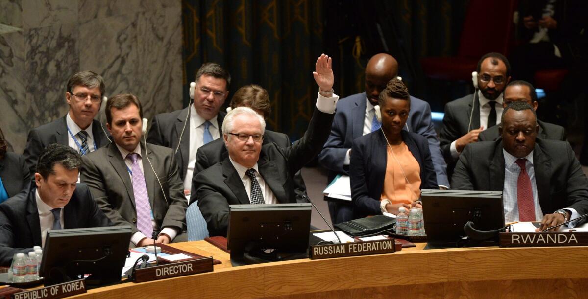 Russian Ambassador to the United Nations Vitaly Churkin votes against a Syria war crimes resolution.