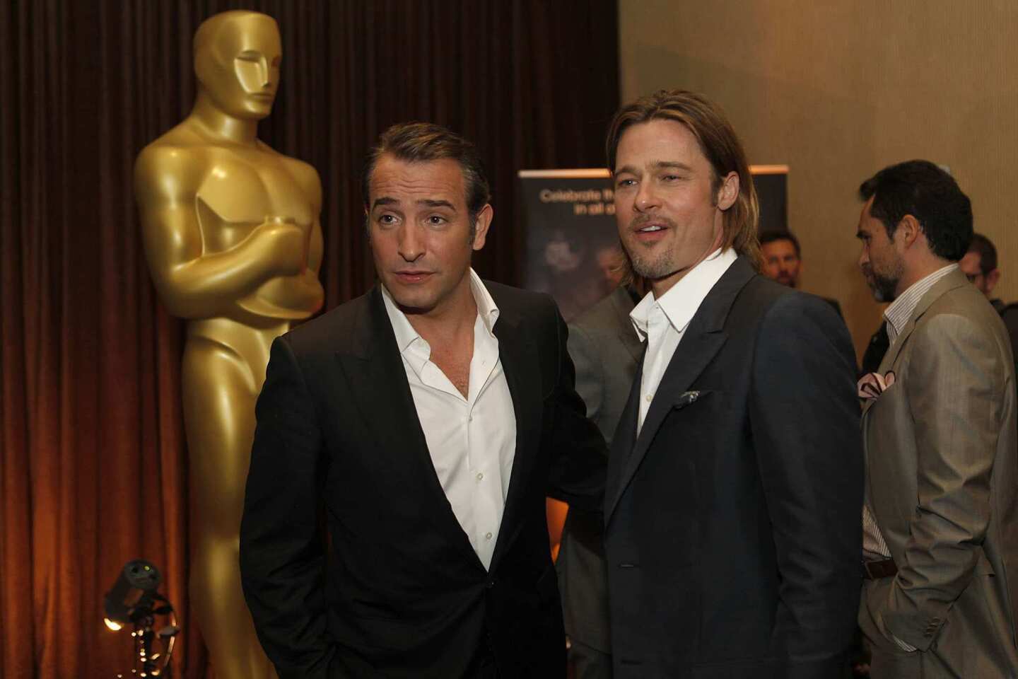 Academy Award contenders Jean Dujardin ("The Artist") and Brad Pitt ("Moneyball," "The Tree of Life") chat at the luncheon.