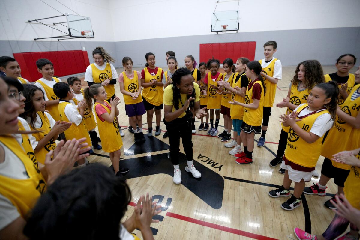 Coach LaSandra Dixon fires up the participants in the L.A. Sparks & DEA 360 basketball clinic at the YMCA in Burbank on Wednesday, Feb. 12.