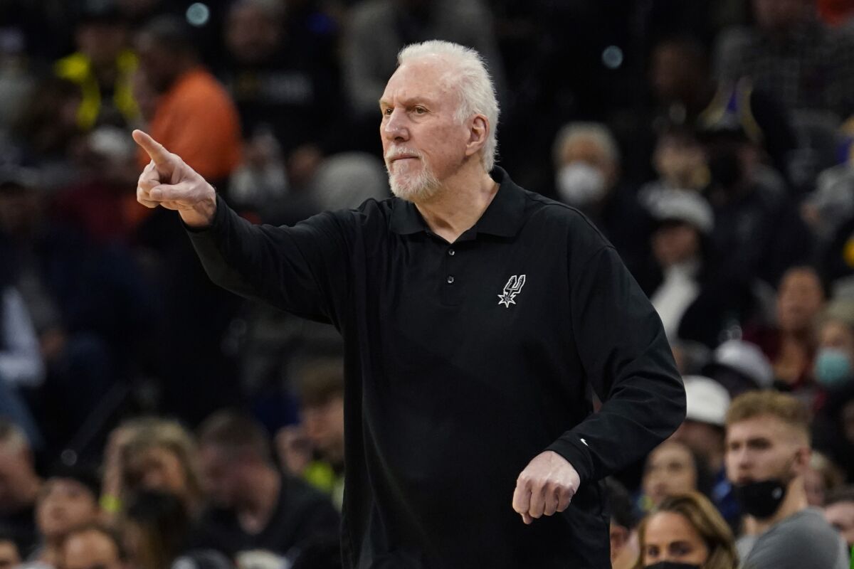 San Antonio Spurs coach Gregg Popovich signals to his players during a game against the Lakers.
