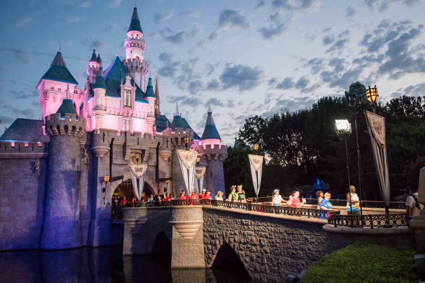 Sleeping Beauty's Castle at Disneyland with runners in a Half Marathon on the bridge. 