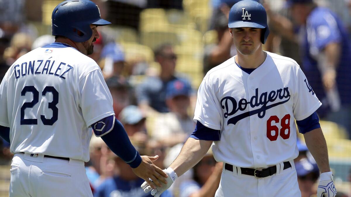 Dodgers first baseman Adrian Gonzalez is congratulated by pitcher Ross Stripling after scoring a run against the Red Sox in the second inning Saturday.
