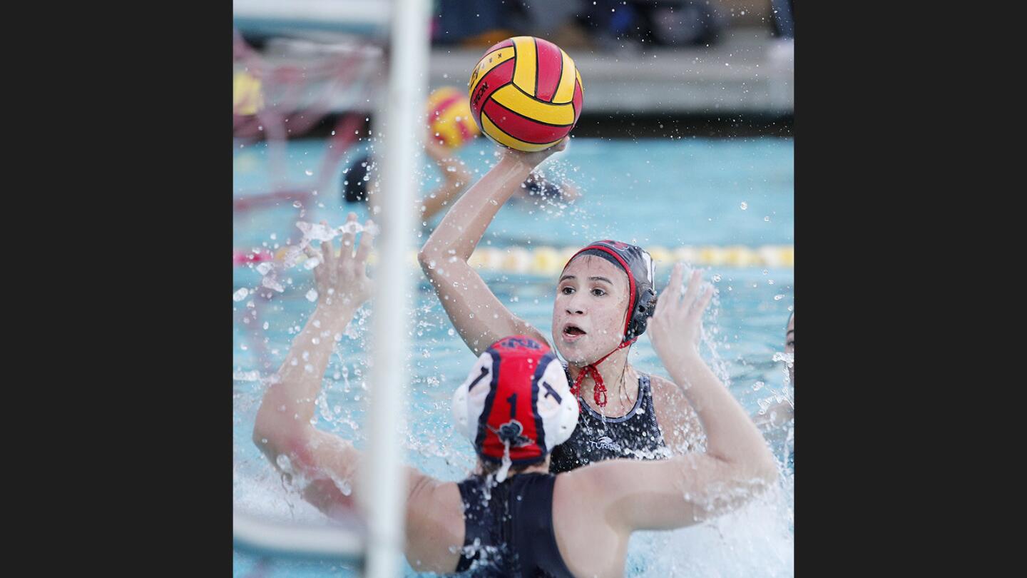 Burroughs' Aleah Orozco pounds a shot into the net to score against Notre Dame in a nonleague girls' water polo match at Burroughs High School on Thursday, December 21, 2017.